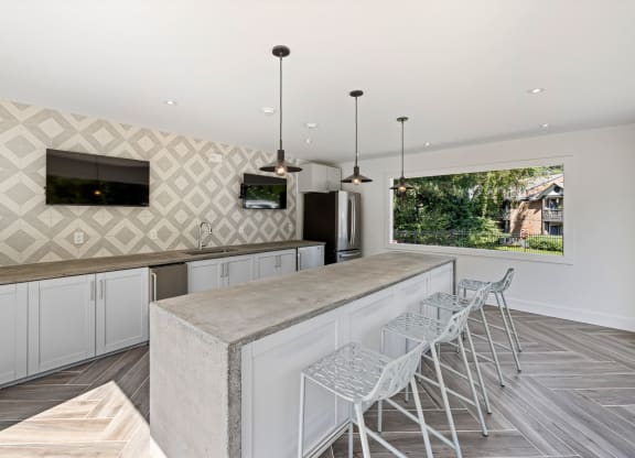 a large kitchen with a long counter and bar stools at View at Lake Lynn, Raleigh, NC