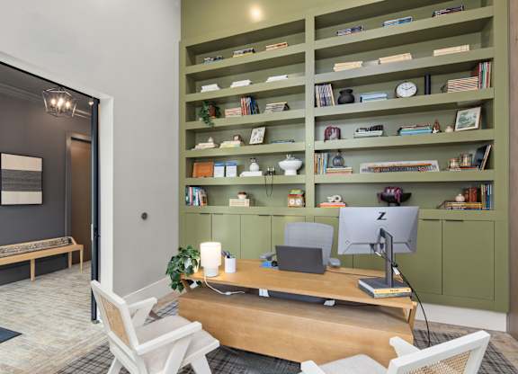 A room with a desk, chair, and bookshelf.
