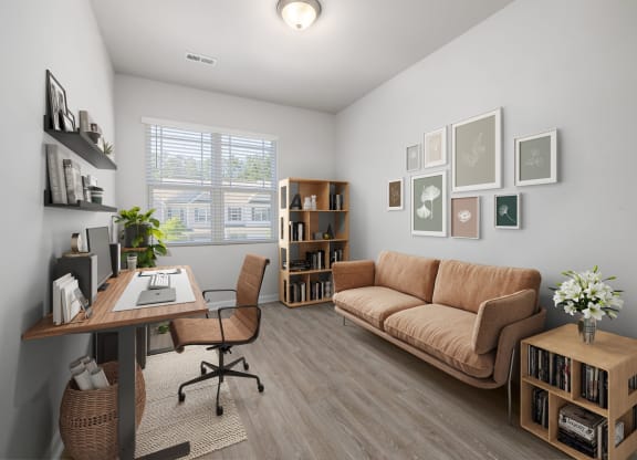 a living room with a couch and a desk