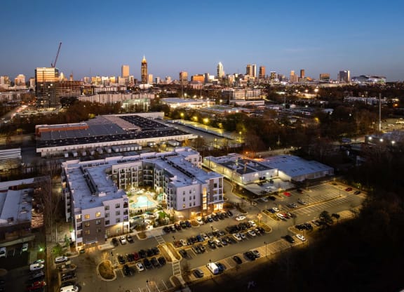 the campus at night with the city skyline in the background