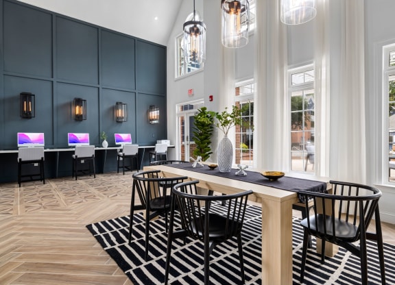 a dining room with black chairs and a wooden table at Mariners Crossing, Raleigh, NC