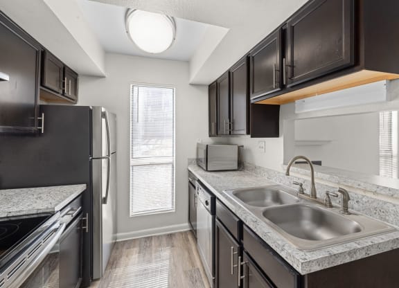 the kitchen of a home with black appliances and granite counter tops