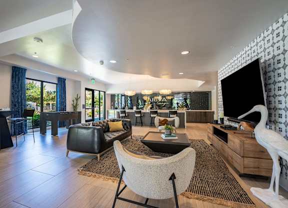 A modern living room with a black and white patterned wall.