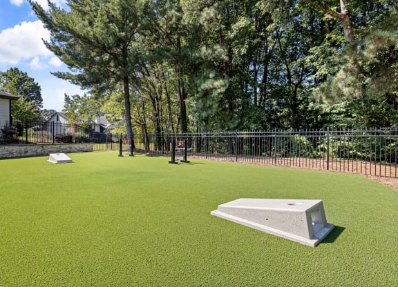 a yard with a pool and a fence and trees at View at Lake Lynn, Raleigh, NC