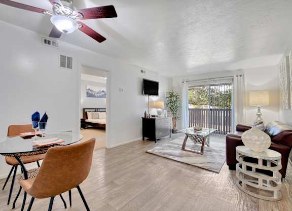 A living room with a brown chair and a glass table.