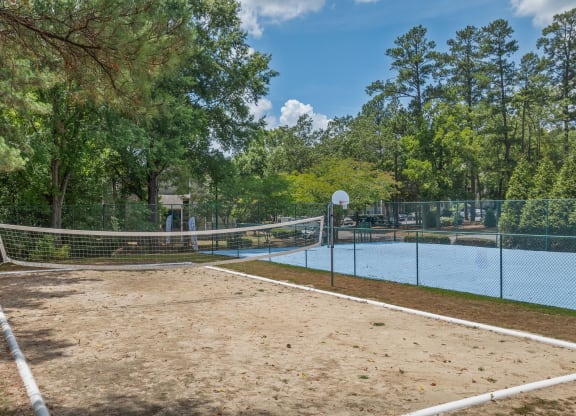 the tennis court is equipped with a net and a pool