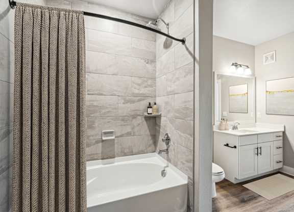 A2 A bathroom with a tub, sink, and shower.