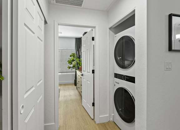 A white laundry room with a washer and dryer.