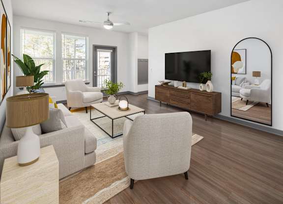 A modern living room with a large television and a mirror on the wall.