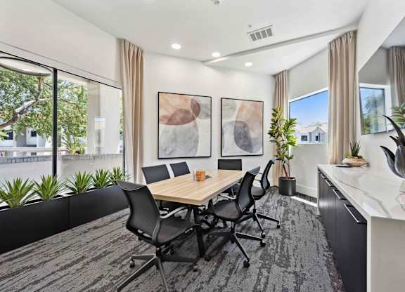 A conference room with a long table and chairs.