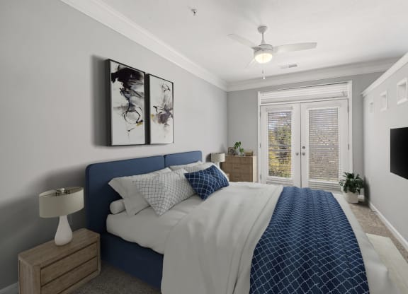 a bedroom with a bed and a ceiling fan