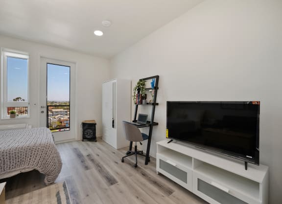 a bedroom with a large tv and a bed