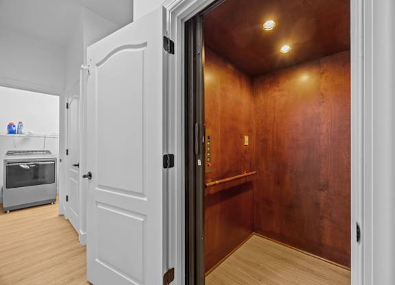 A laundry room with a washing machine and dressing room