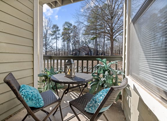 a patio with a table and chairs on a balcony