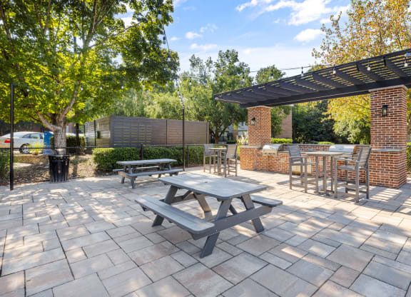 a patio with a picnic table and benches at View at Lake Lynn, Raleigh North Carolina