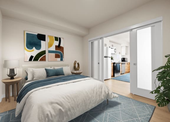 a bedroom with white walls and a large bed with blue and white bedding at Ion Town Center, Shoreline