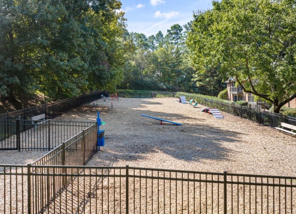 a playground in a park with benches and trees at View at Lake Lynn, Raleigh, 27613