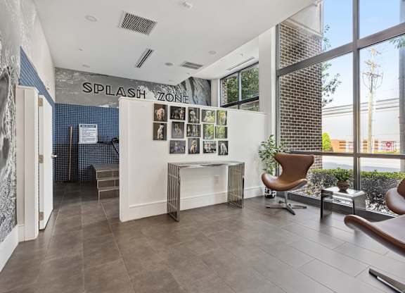 an office with a large window and a desk with a chair