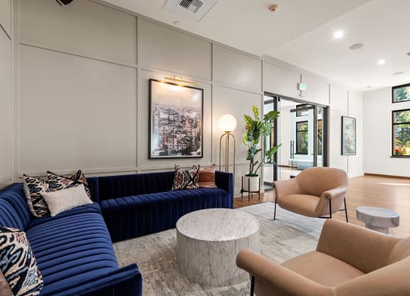 a living room with couches and chairs and a table