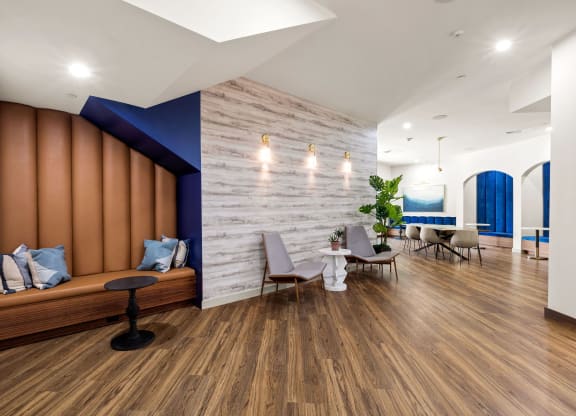 a living room with wooden floors and a blue accent wall
