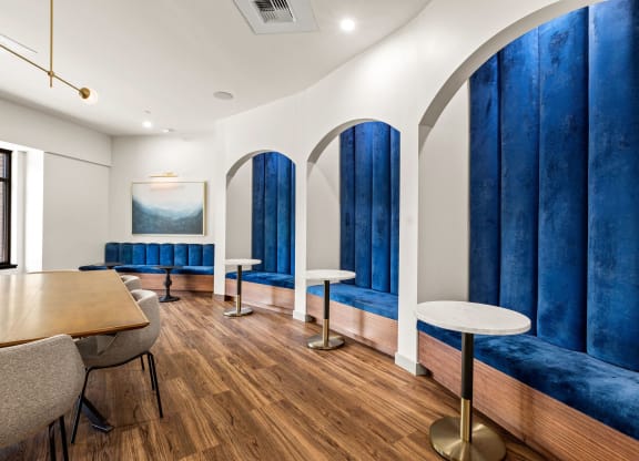 a dining room with blue booths and tables