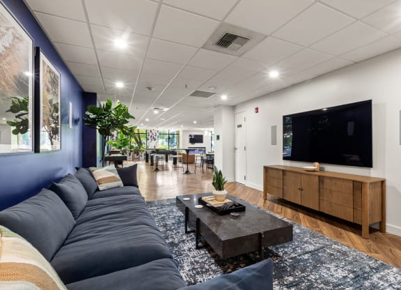 a living room with a blue couch and a tv