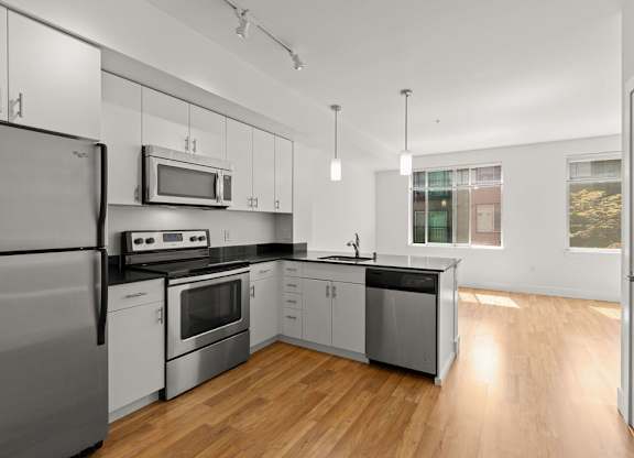 Modern kitchen with stainless steel appliances at Six Oaks Apartments, Bothell, 98011