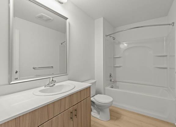 Bathroom with soaking tub and builtin shelving at Six Oaks Apartments, Bothell