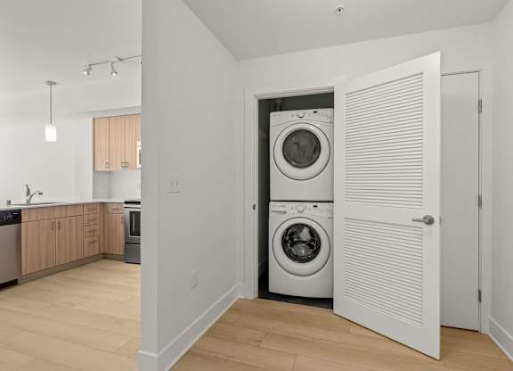 Stacked washer and dryer in laundry closet at Six Oaks Apartments, Washington