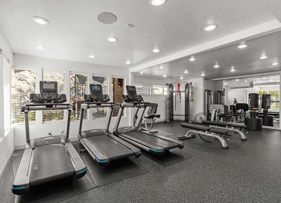Fitness center with cardio and weight equipment at Scout Apartments, Kirkland