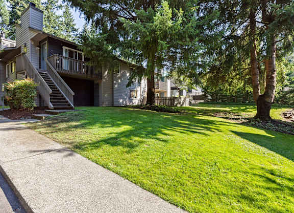 Apartment building with outdoor staircase and lawn area at Scout Apartments, Kirkland, WA 98034