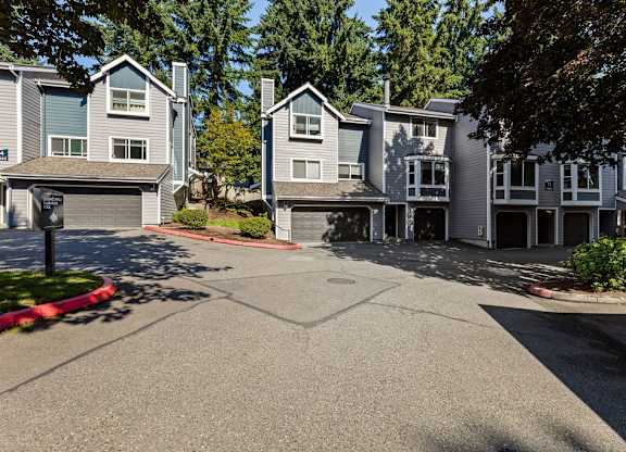 Townhome exterior with private garages at Hidden River Townhomes Apartments, Kirkland