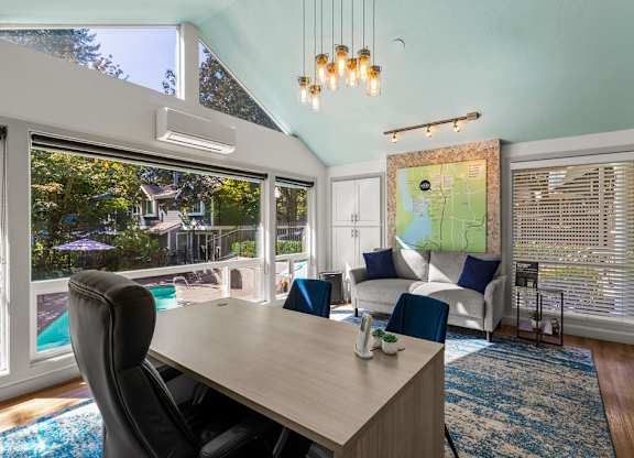 Open concept living and dining area with vaulted ceiling at Hidden River Townhomes Apartments, Washington