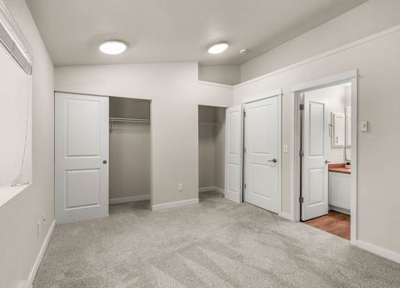 Spacious bedroom with walk-in closets and ensuite bathroom at Hidden River Townhomes Apartments, Washington