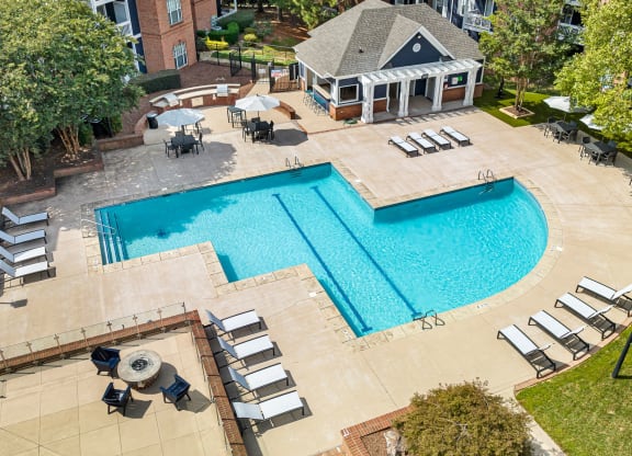 an overhead view of a swimming pool and patio with chairs at Mariners Crossing, Raleigh, 27613