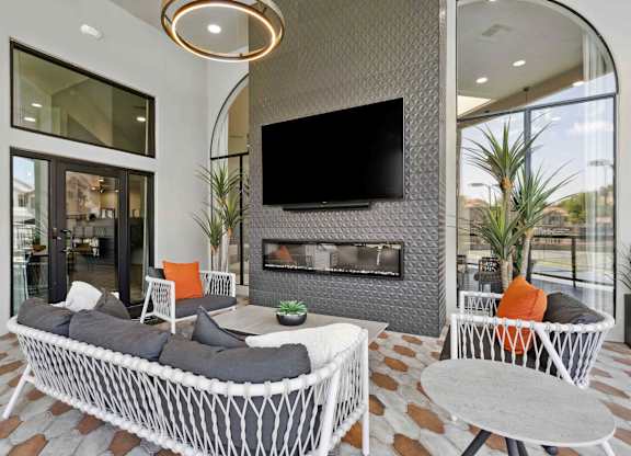 A modern living room with a fireplace and a television.