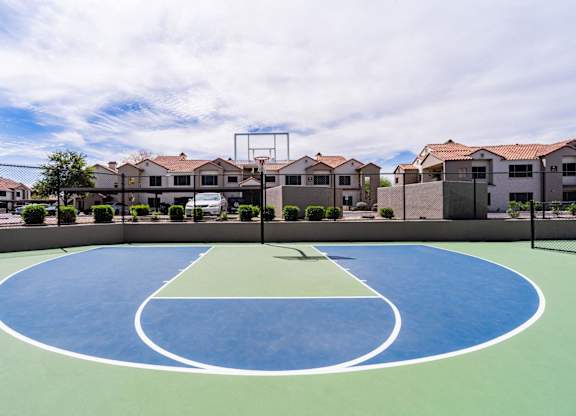 A basketball court in the middle of a housing complex.