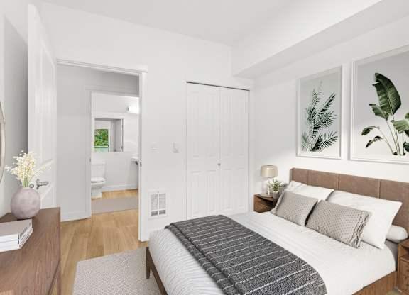 A bedroom with a large bed and a mirror on the wall.