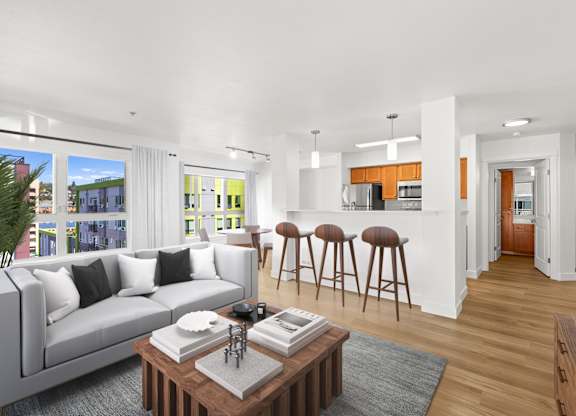 A modern living room with a grey sofa and a coffee table.