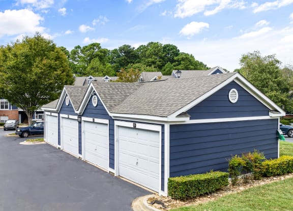 a blue and white garage with a brick building behind it at Mariners Crossing, Raleigh North Carolina 