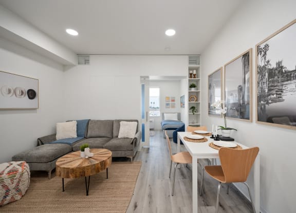 a living room with a table and chairs and a couch