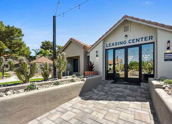 A leasing center with a brick walkway leading to the entrance.
