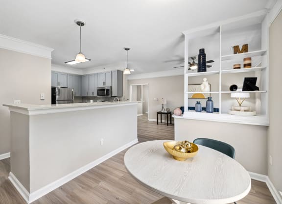 an open kitchen and dining room with a white counter top and a table at Mariners Crossing, Raleigh North Carolina