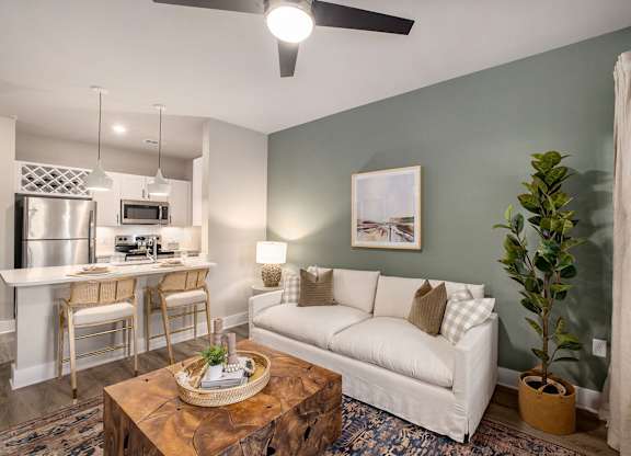 an open living room and kitchen with a couch and a table