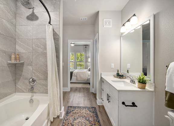 a bathroom with a shower and a sink and a bath tub