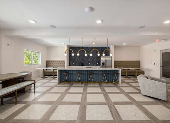 a clubhouse with a bar and seating area with chairs and a table