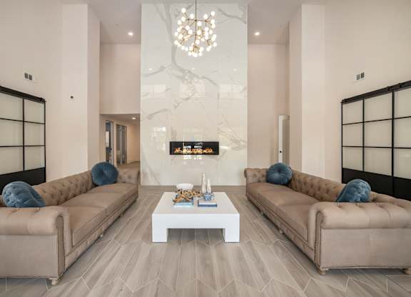 a living room with two couches and a white coffee table