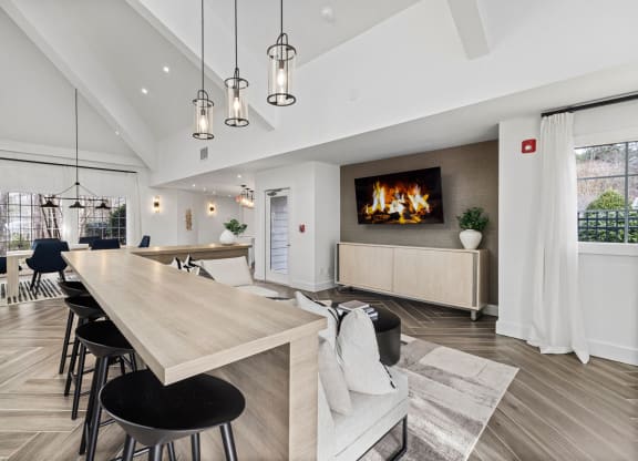 a living room with a fireplace and a table and chairs
