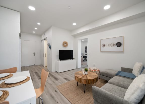 a living room with a couch and a table and a television