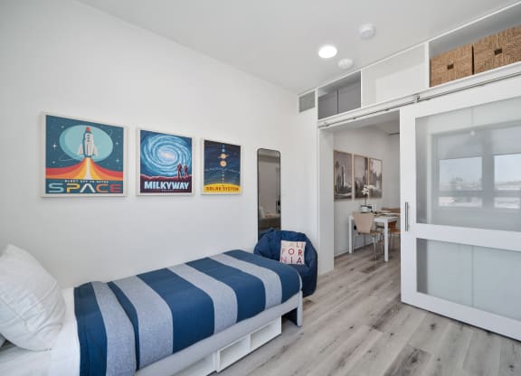 a bedroom with a bunk bed and a door to a bathroom